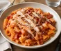 Creamy tomato rigatoni with grilled chicken, crisp bacon and Parmesan